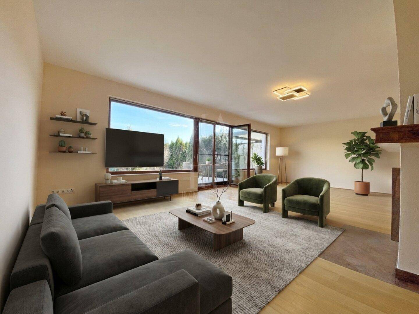 Gemütliches Wohnzimmer mit großem Sofa, Fernseher und Blick ins Grüne, perfekt für Filmabende.