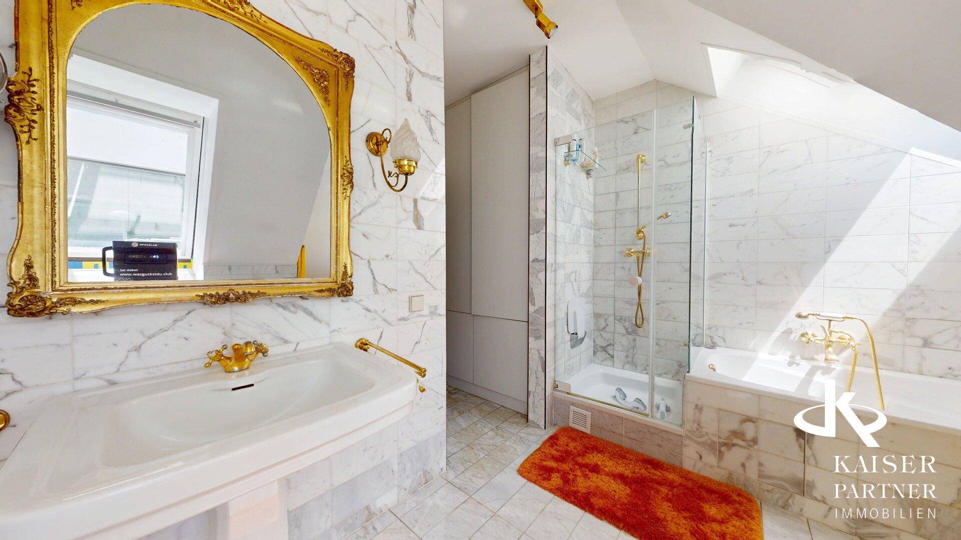 Luxuriöses Badezimmer im Dachgeschoss mit Marmorfliesen, Dusche und Badewanne.