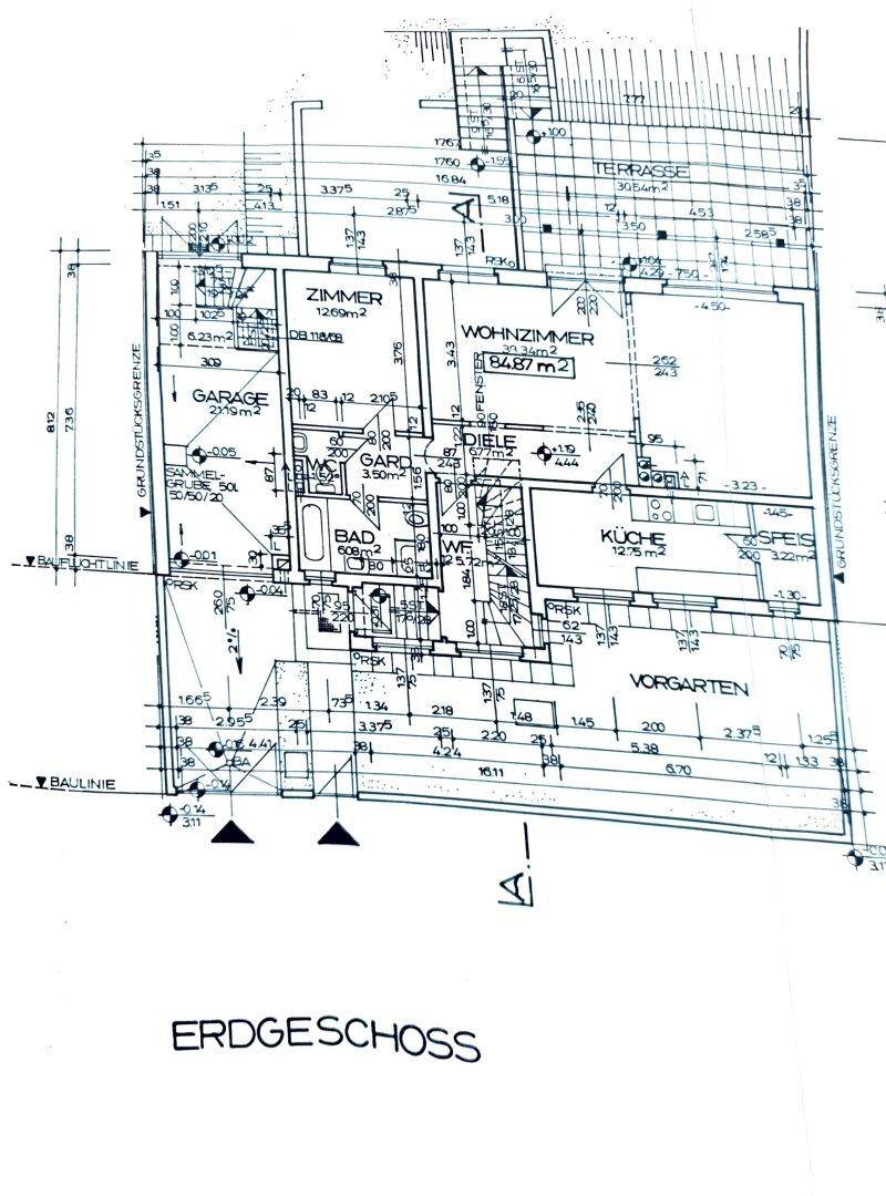 Grundriss des Erdgeschosses mit Wohnzimmer, Küche, Garage und Terrasse.