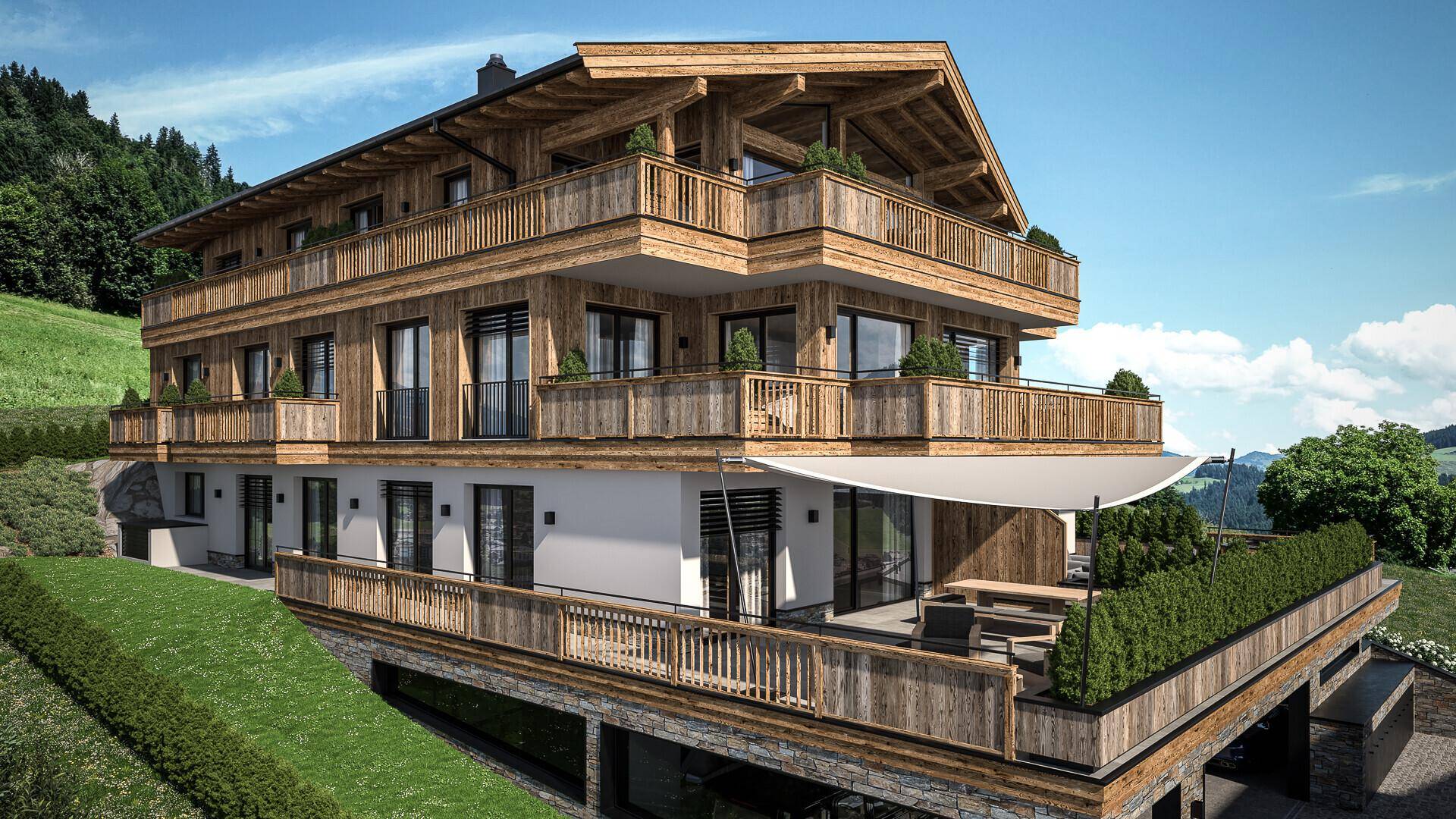 Modernes Chalet mit großer Terrasse, Sonnensegel und integriertem Carport, umgeben von grüner Natur und Bergen.