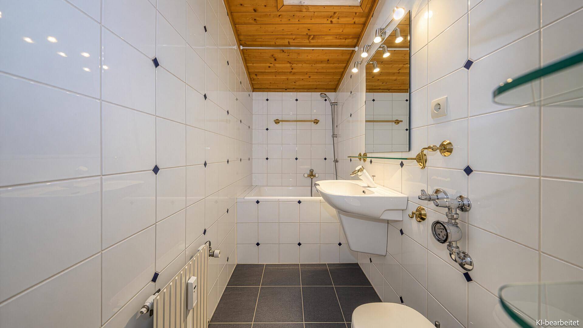 Traditionelles Badezimmer mit weißen Fliesen, blauen Akzenten, Badewanne und Holzdecke.