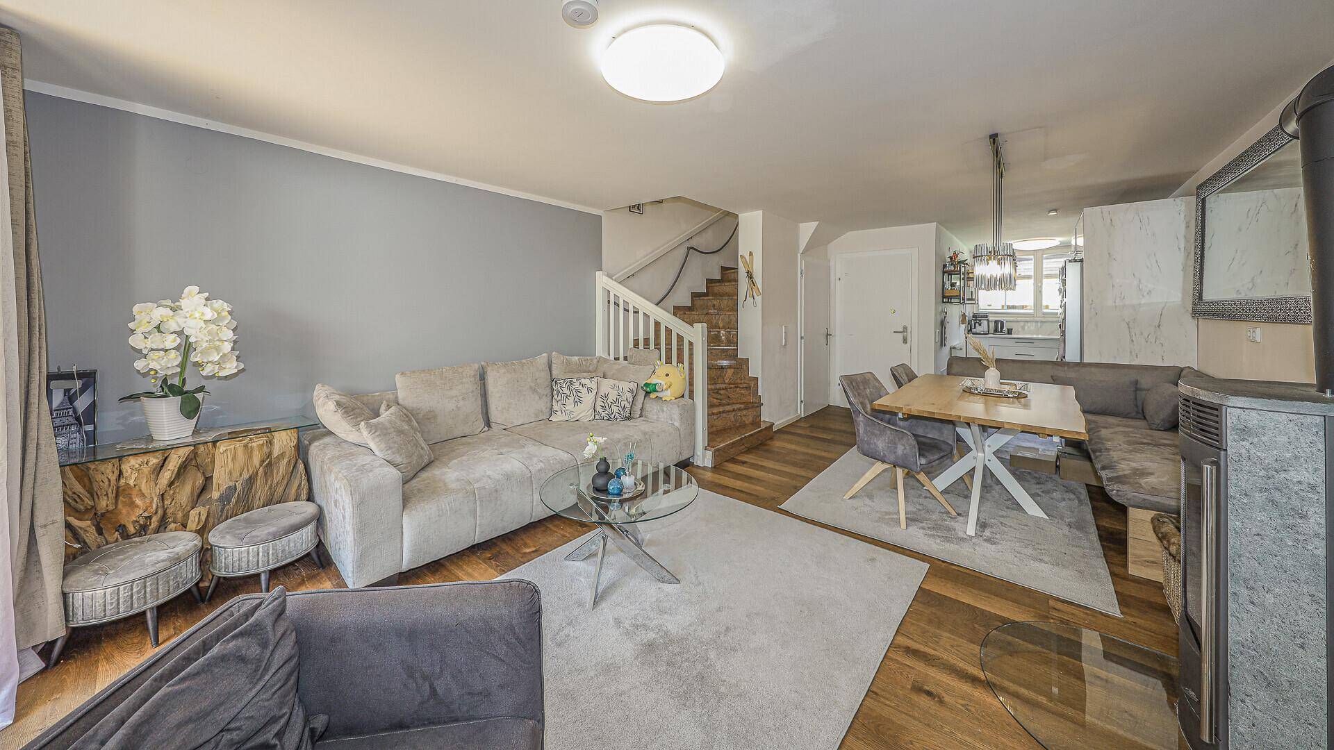 Geräumiger Wohn-Essbereich mit Treppe, Holzboden und moderner Einrichtung.