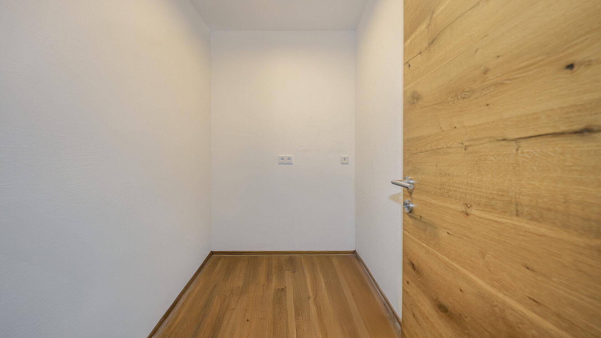Praktischer Abstellraum mit Holzboden und Steckdosen für verschiedene Zwecke.