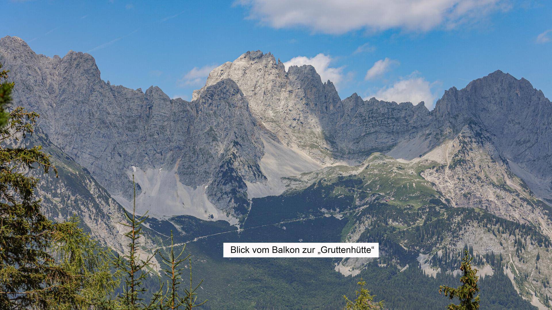 Atemberaubender Blick vom Balkon auf die imposante Berglandschaft und die Gruttenhütte.