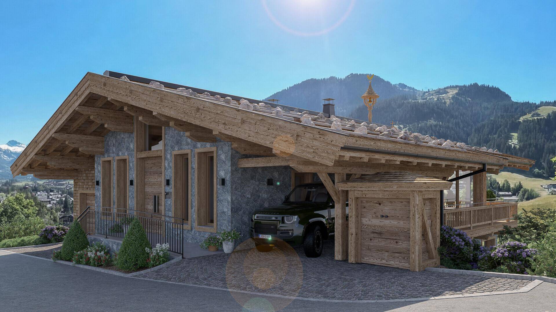 Modernes Chalet im alpinen Stil mit Carport und Bergblick unter strahlend blauem Himmel.