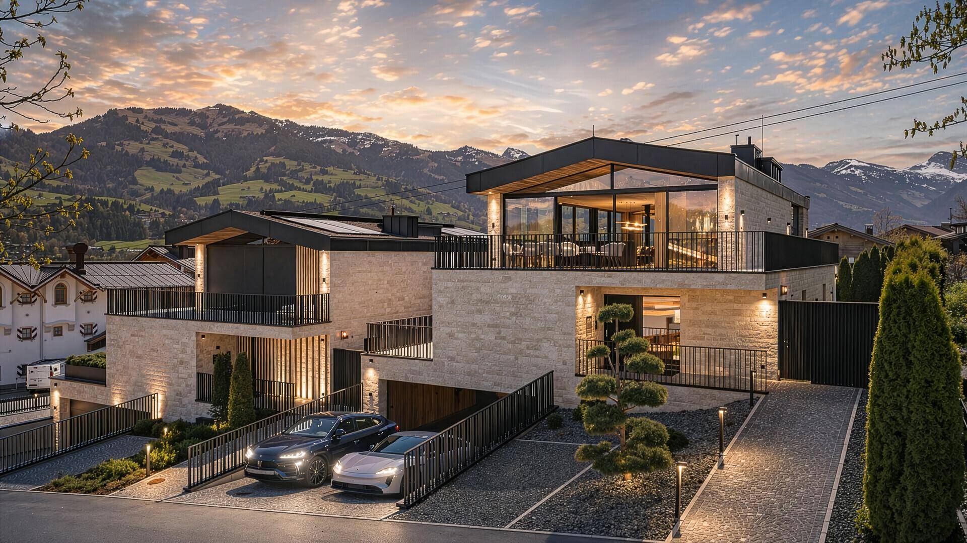 Elegante Villa bei Sonnenuntergang, beleuchtet und mit Bergblick, präsentiert moderne Architektur und Luxus.