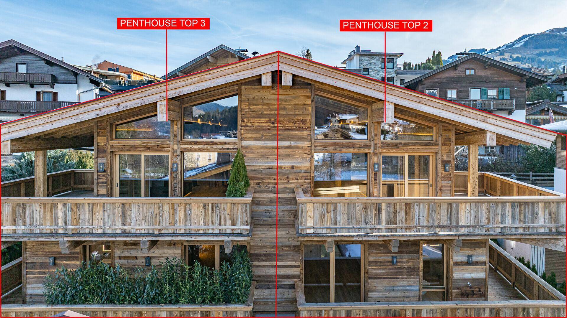 Ansicht des Holzchalets mit markierten Penthouse-Einheiten und umliegender Bebauung.