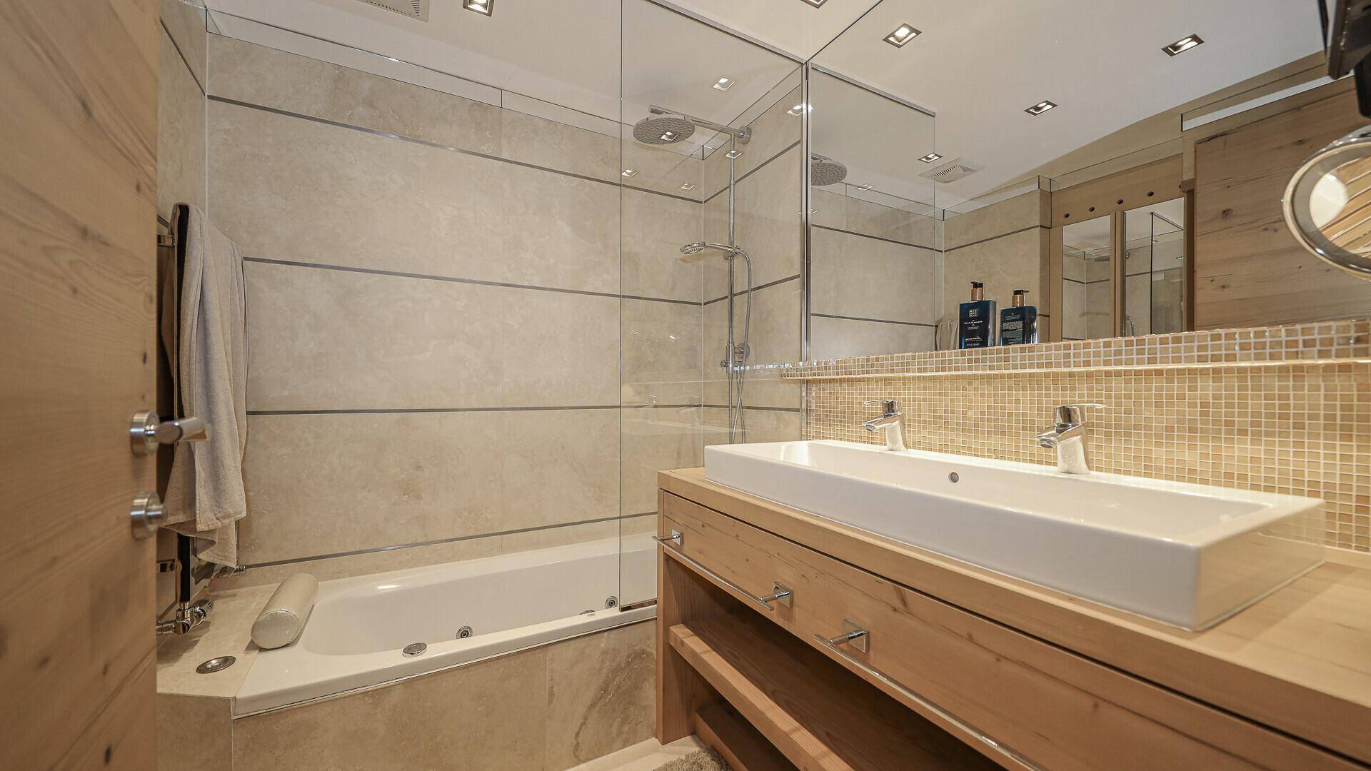 Modernes Badezimmer mit Doppelwaschbecken, Badewanne und begehbarer Dusche.