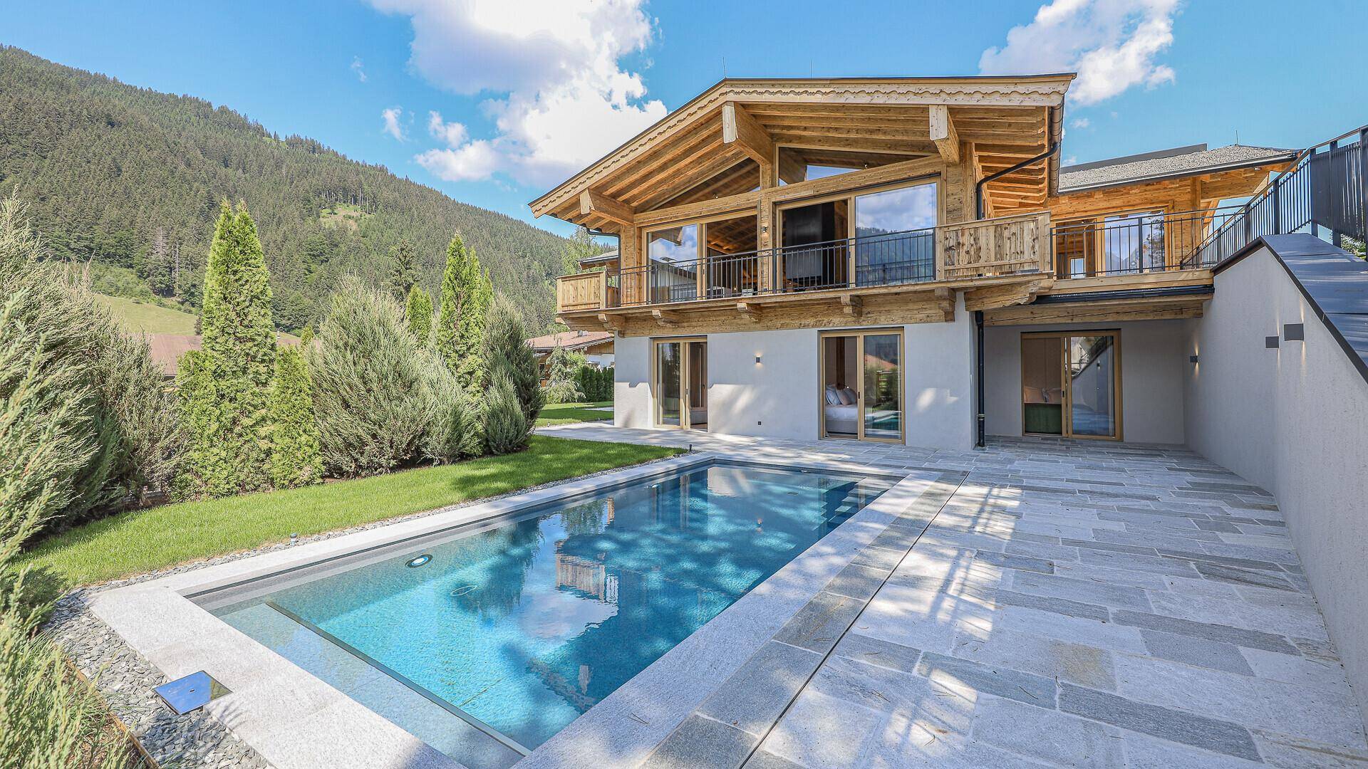 Exklusives Chalet mit Außenpool und gepflegtem Garten in sonniger Lage mit Bergblick.
