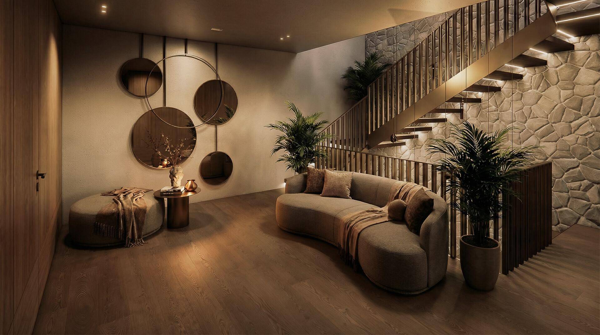 Geräumiger Flur mit geschwungenem Sofa, dekorativen Spiegeln und einer eleganten Treppe mit Steinwand.