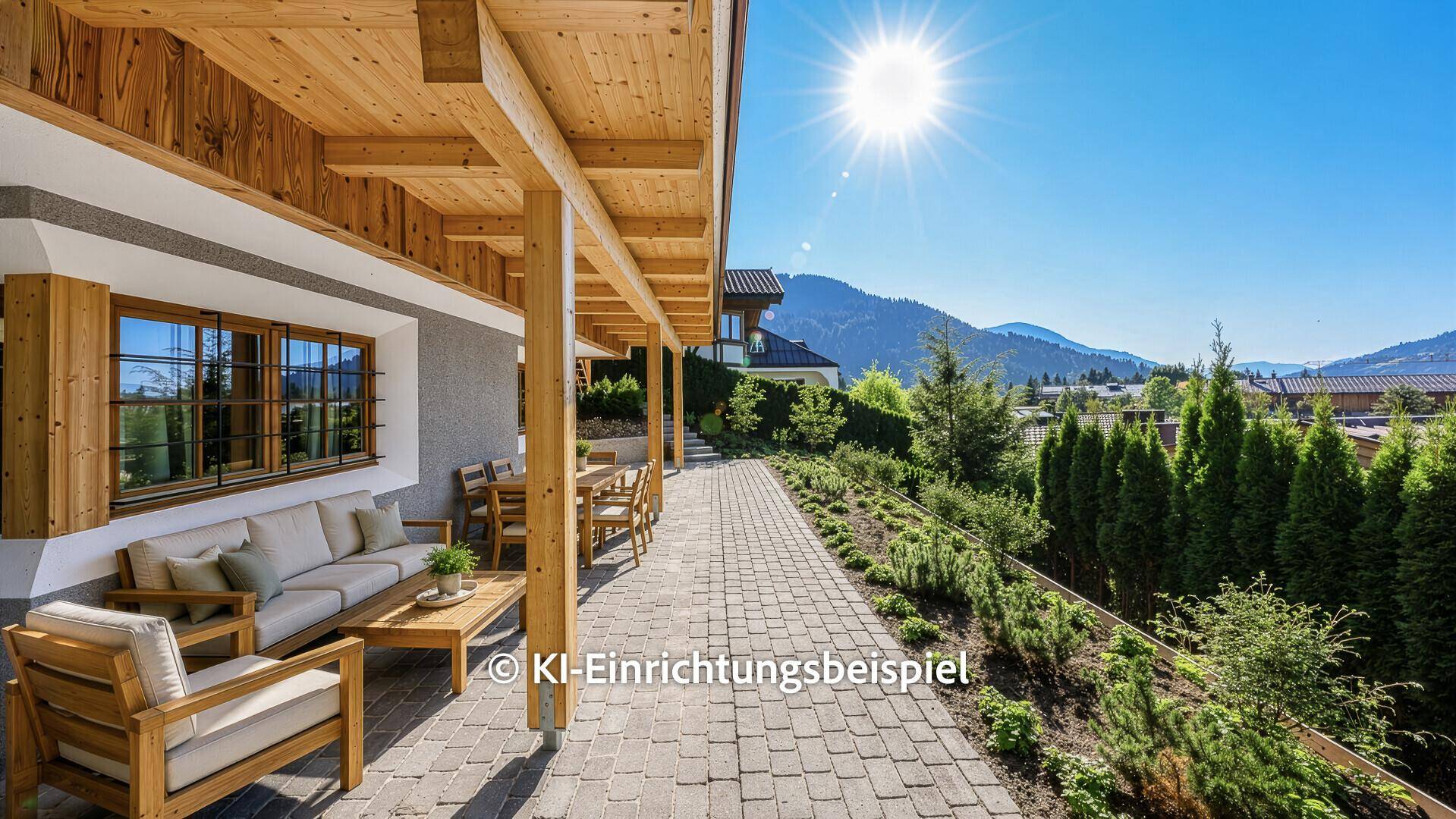 Sonnige, überdachte Terrasse mit bequemen Loungemöbeln und weitem Blick auf die umliegende Berglandschaft.