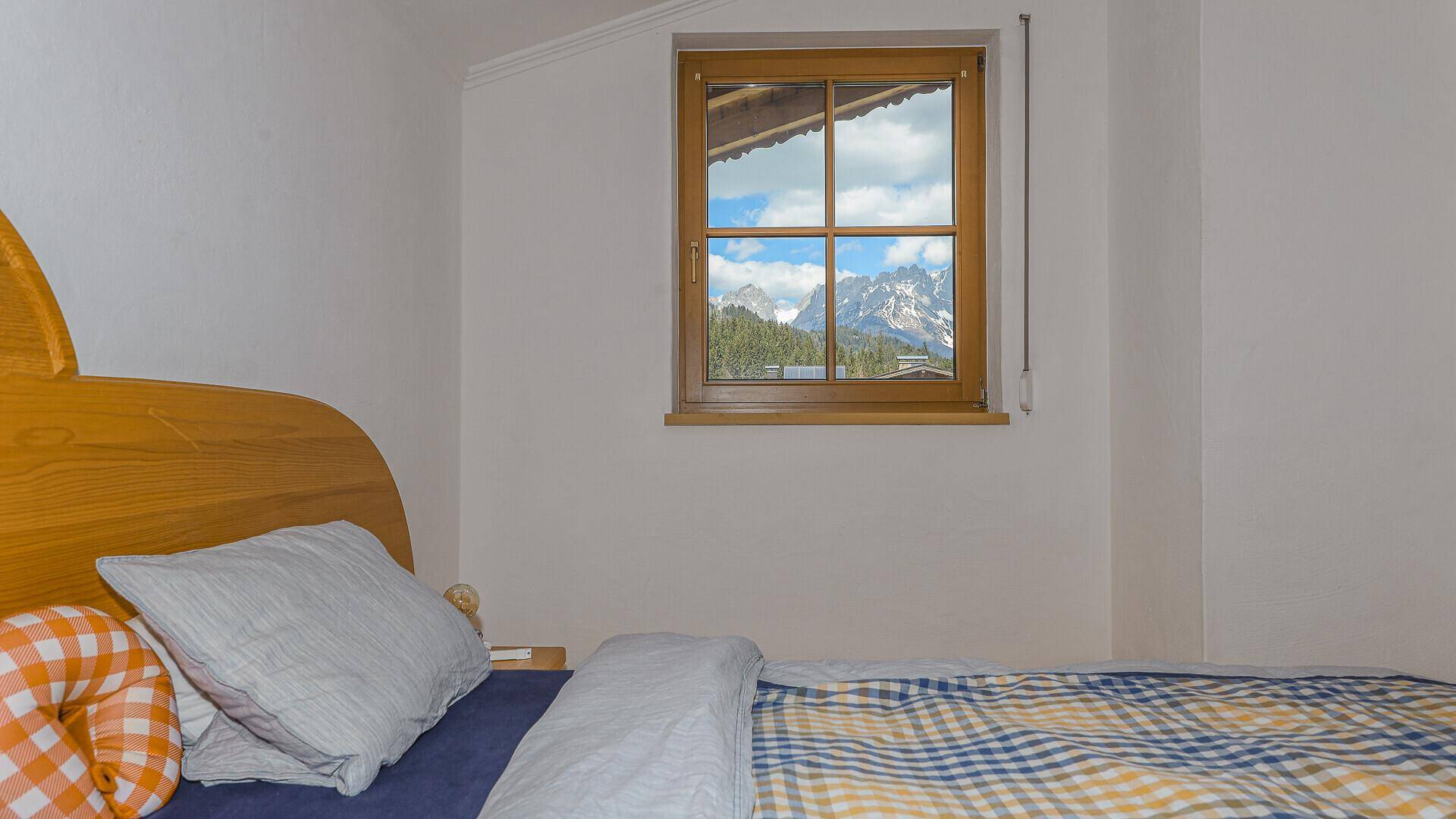 Fenster im Schlafzimmer mit herrlichem Blick auf die umliegenden Berge.