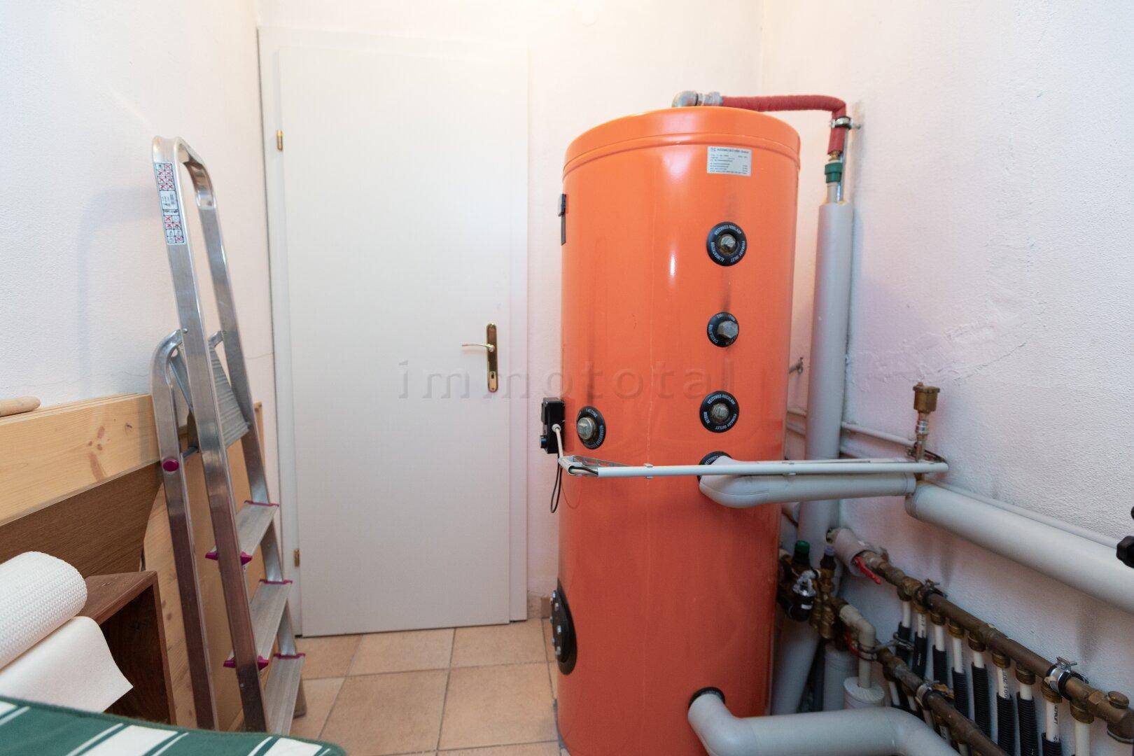 Hauswirtschaftsraum mit Warmwasserspeicher und Heizungsinstallationen.