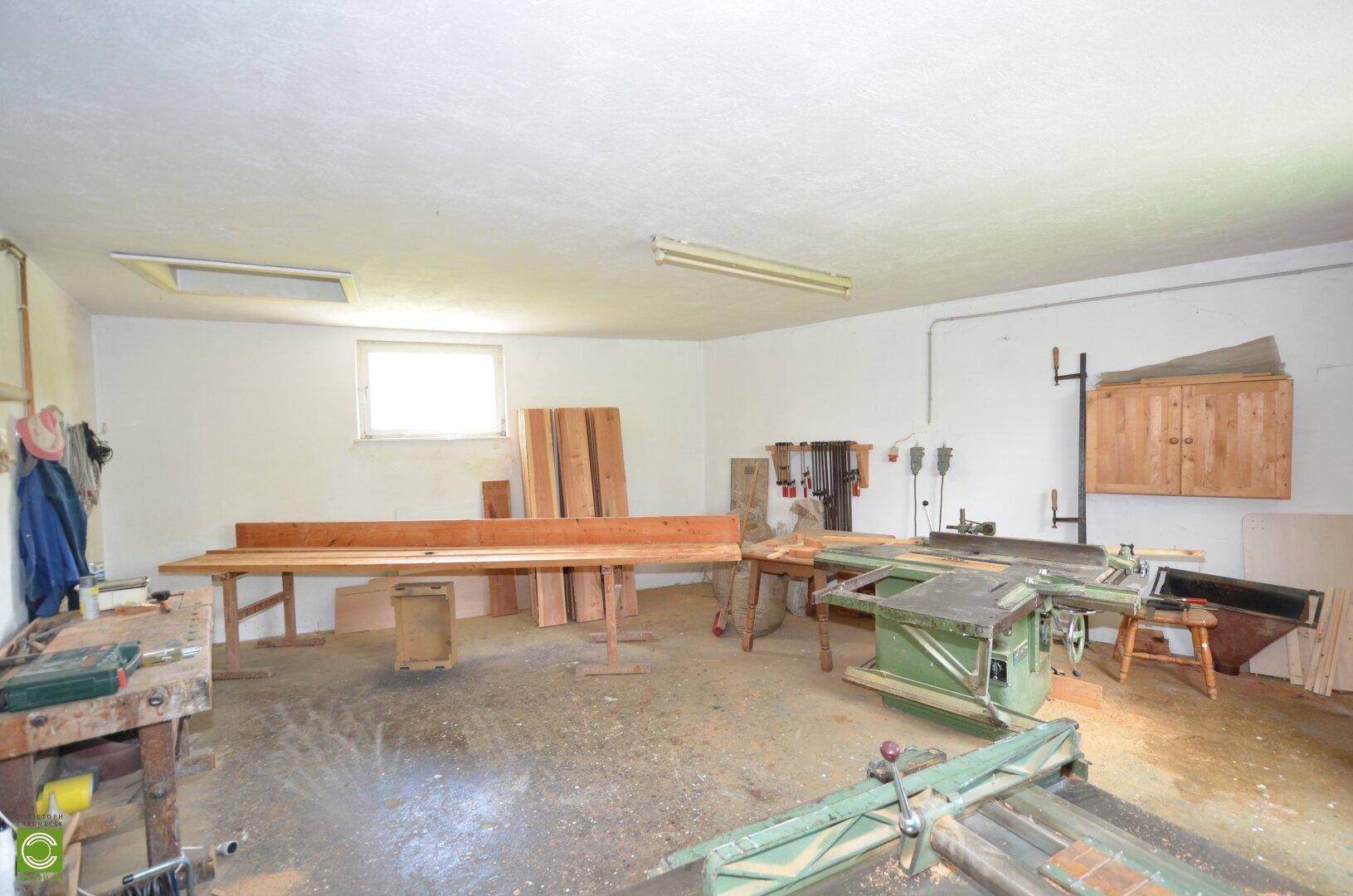Große Werkstatt mit umfangreicher Ausstattung für Holzbearbeitung und ausreichend Arbeitsfläche.