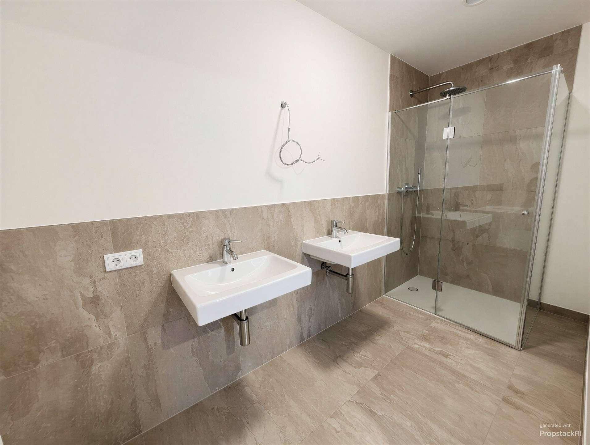 Modernes Badezimmer mit zwei Waschbecken, großer begehbarer Dusche und grauen Fliesen.