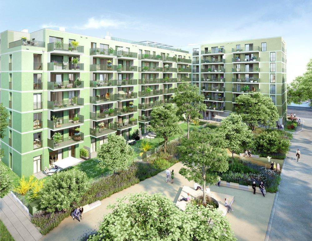 Moderne Wohnanlage mit grüner Fassade, zahlreichen Balkonen und weitläufigen Grünflächen.