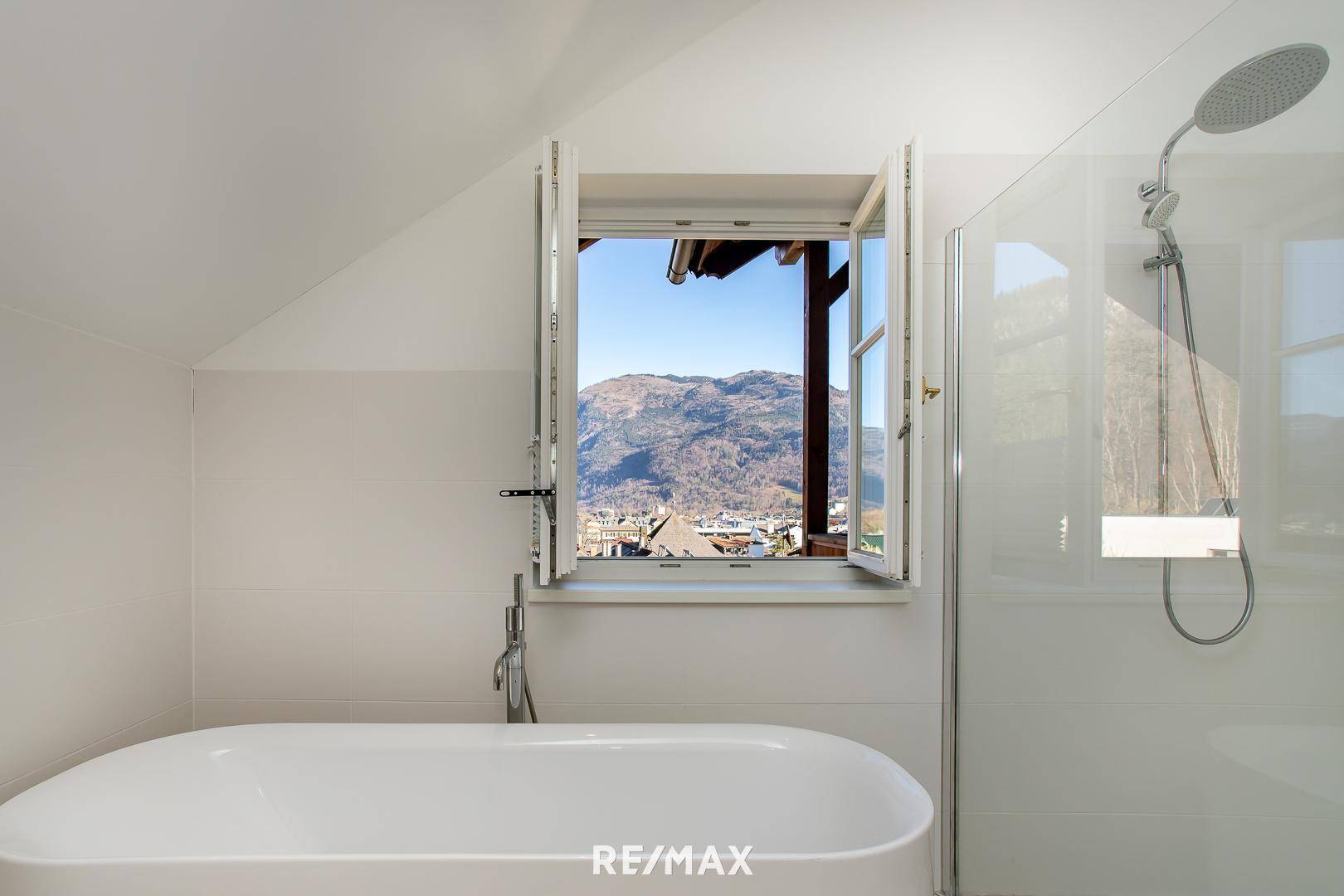 Fenster im Badezimmer bietet einen malerischen Blick auf die umliegende Berglandschaft.