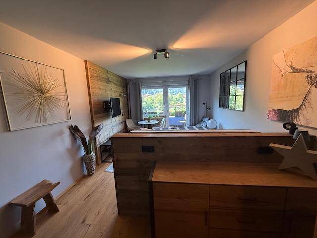 Modernes Schlafzimmer mit Holzelementen, Kunstwerken und Zugang zum Außenbereich.