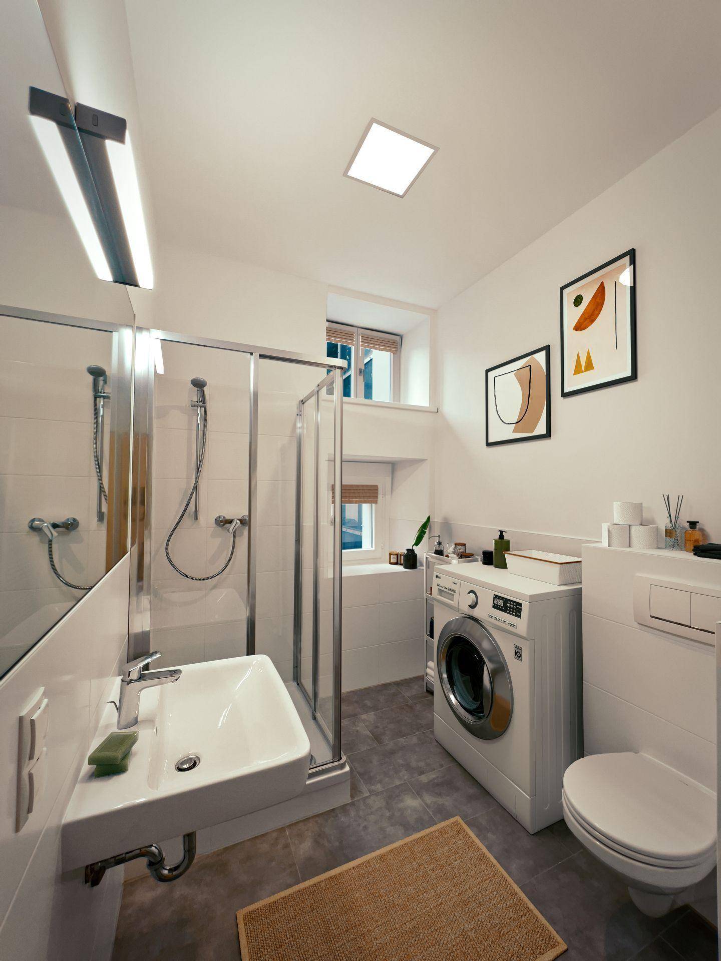 Modernes Badezimmer mit Duschkabine, Waschmaschine und Tageslicht.