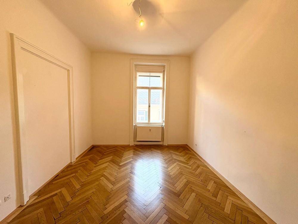 Gemütliches Zimmer mit klassischem Fischgrätparkett und einem Fenster, vielseitig nutzbar.