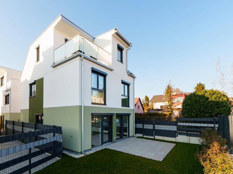 Modernes Reihenhaus mit kleinem Garten, Terrasse und Balkon in sonniger Lage.