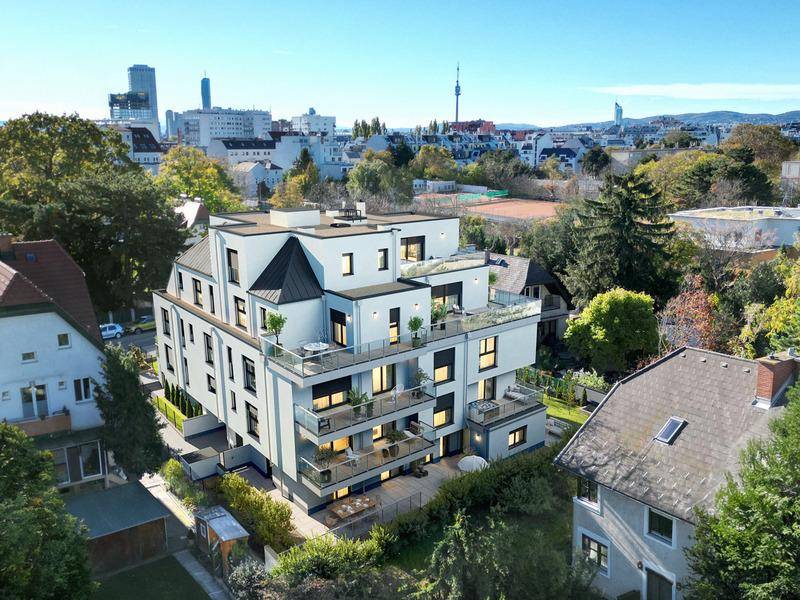 Luftaufnahme des modernen Wohnkomplexes mit Blick auf die Stadtlandschaft und umliegende Gebäude.