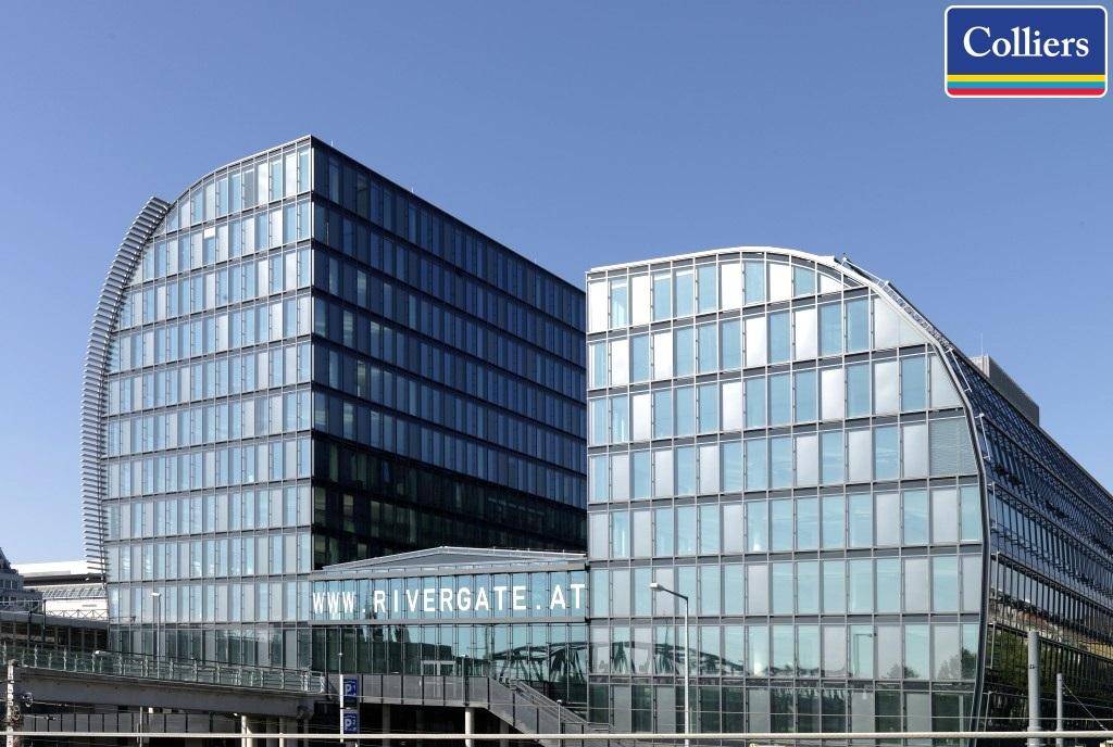 Moderne Bürogebäude mit geschwungenen Glasfassaden und klarem Himmel, repräsentiert zeitgenössische Architektur.