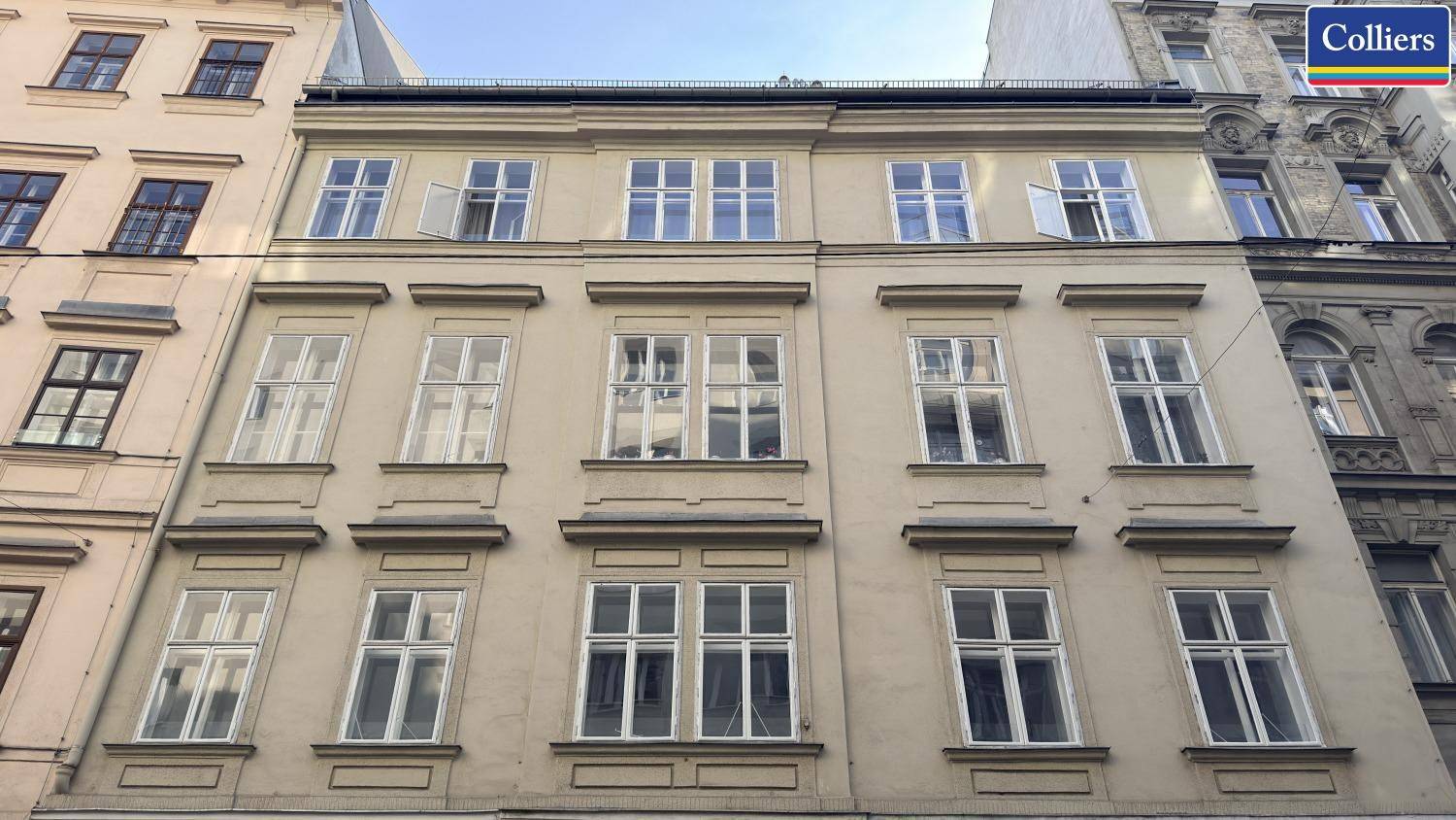 Klassische Fassade eines Altbaus mit vielen Fenstern und traditionellen Details in der Stadt.