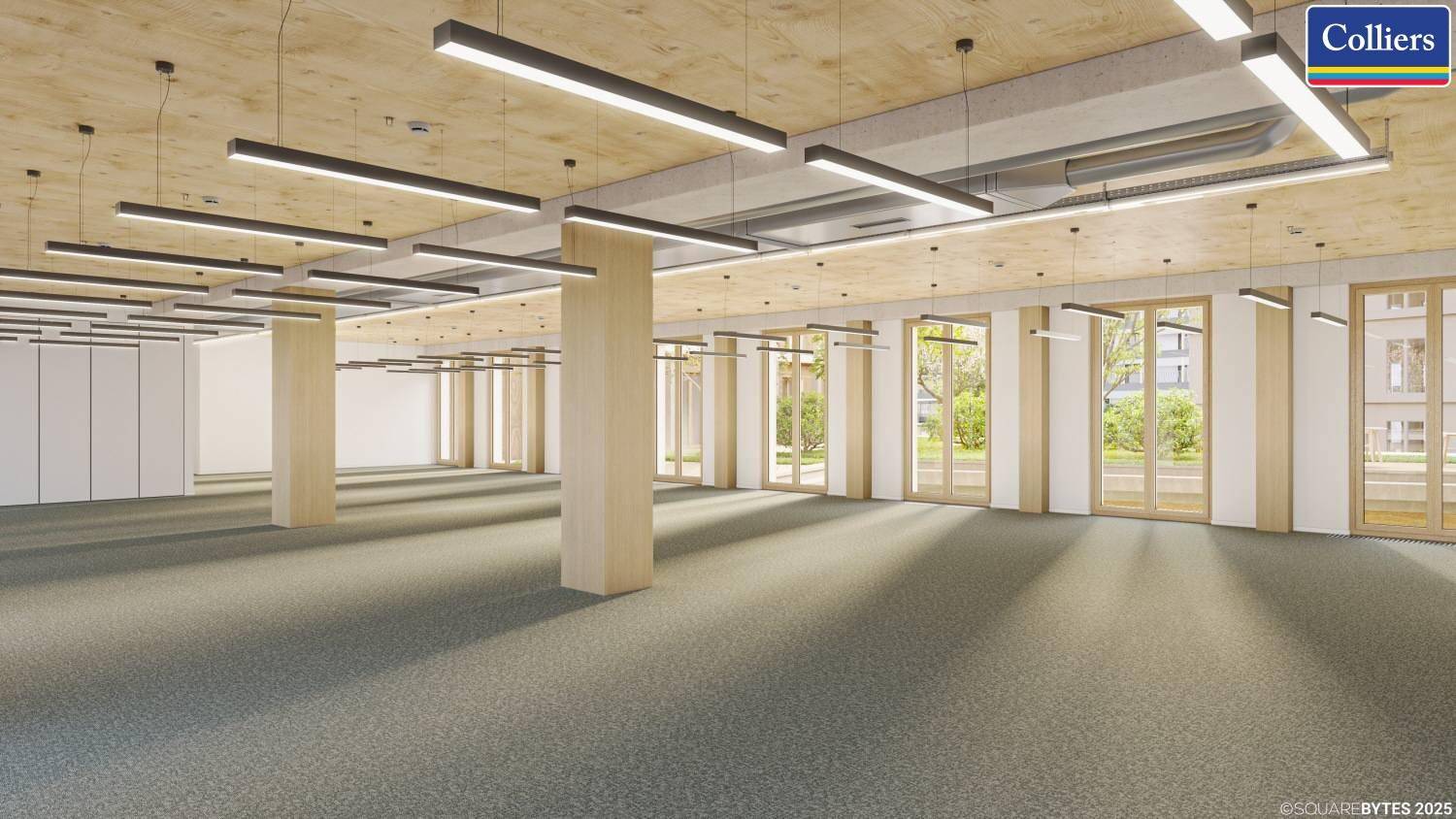 Großer, leerer Büroraum mit Teppichboden, hohen Decken und vielen Fenstern für natürliches Licht.