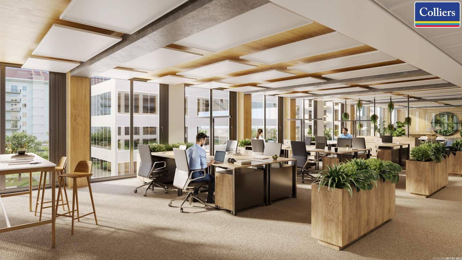 Heller Großraumbüro mit ergonomischen Arbeitsplätzen, viel Grün und großen Fensterfronten.