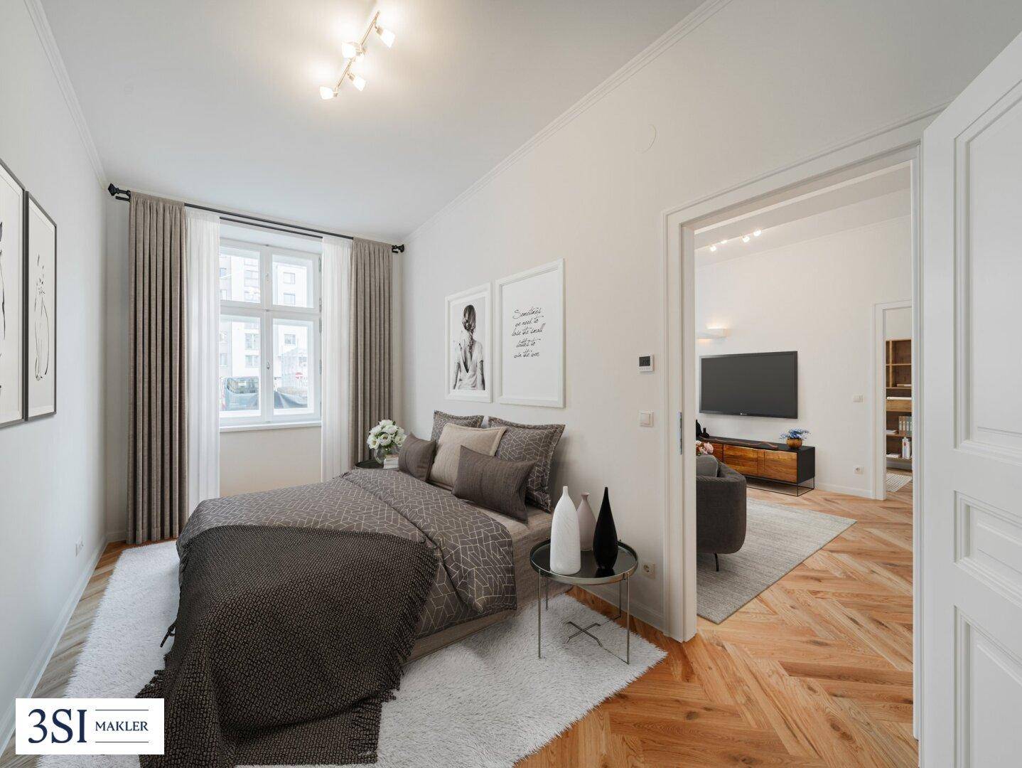 Helles Schlafzimmer mit Fischgrätparkett, modernem Bett und Zugang zum Wohnbereich.