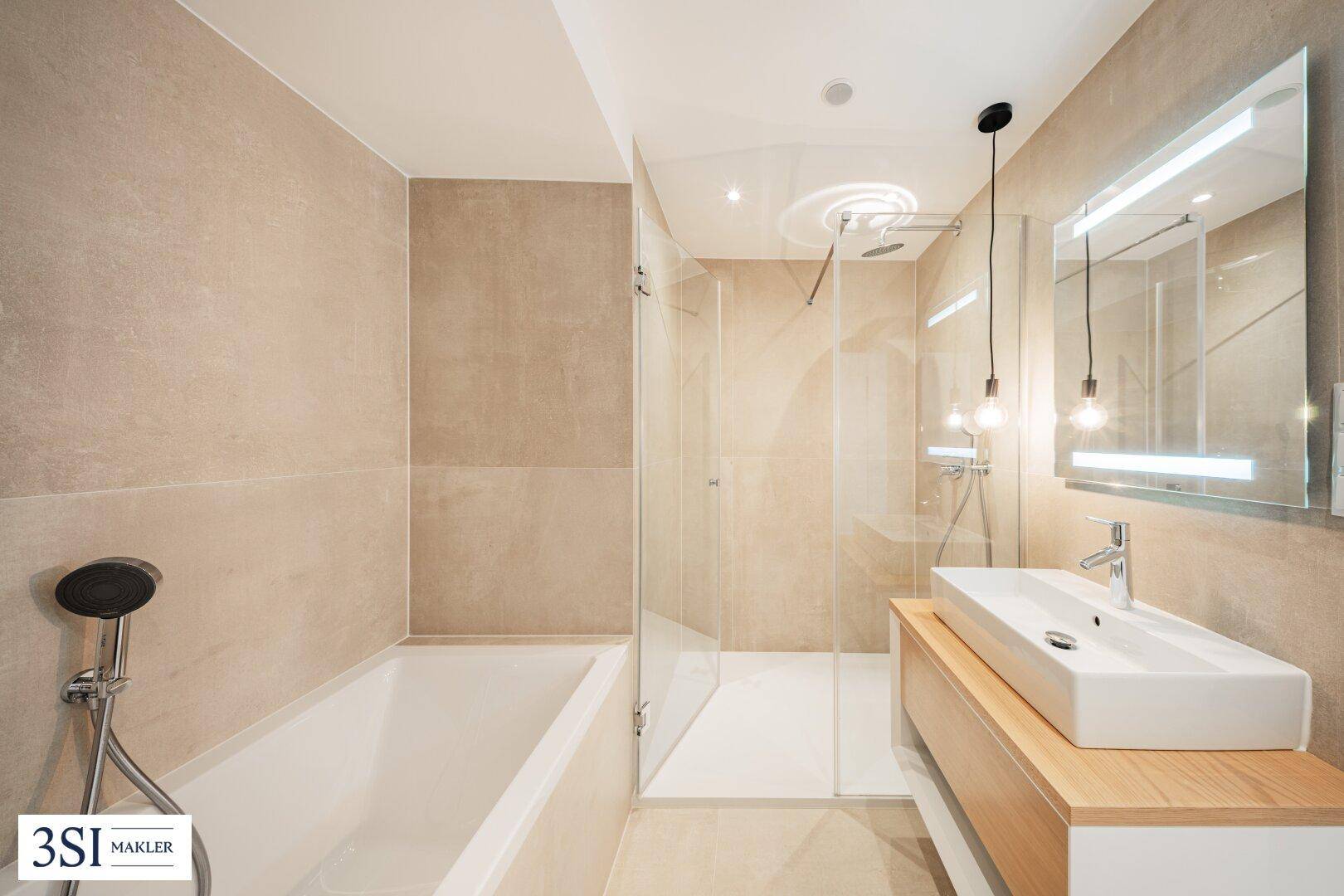 Modernes Badezimmer mit beigefarbenen Fliesen, Badewanne, Dusche und Einzelwaschbecken.