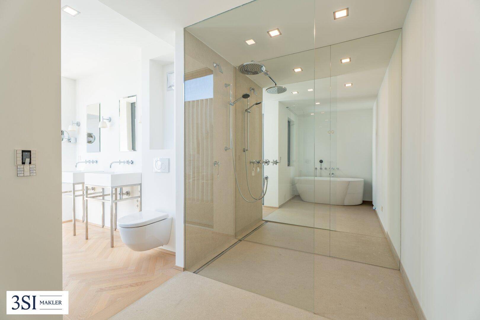 Luxuriöses Badezimmer mit großer begehbarer Dusche, freistehender Badewanne und Doppelwaschbecken.