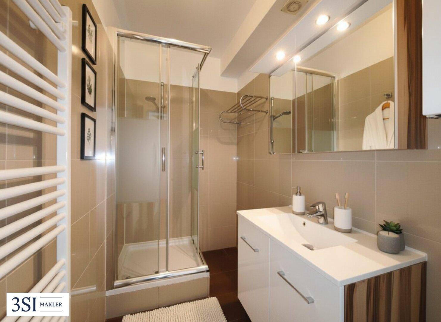 Modernes Badezimmer mit Duschkabine, Einzelwaschbecken und praktischem beheiztem Handtuchhalter.