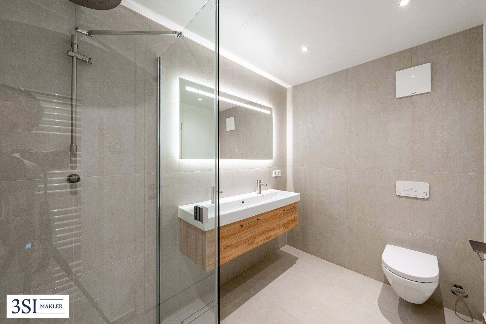 Modernes Badezimmer mit begehbarer Dusche, schwebendem Waschtisch und wandhängendem WC.