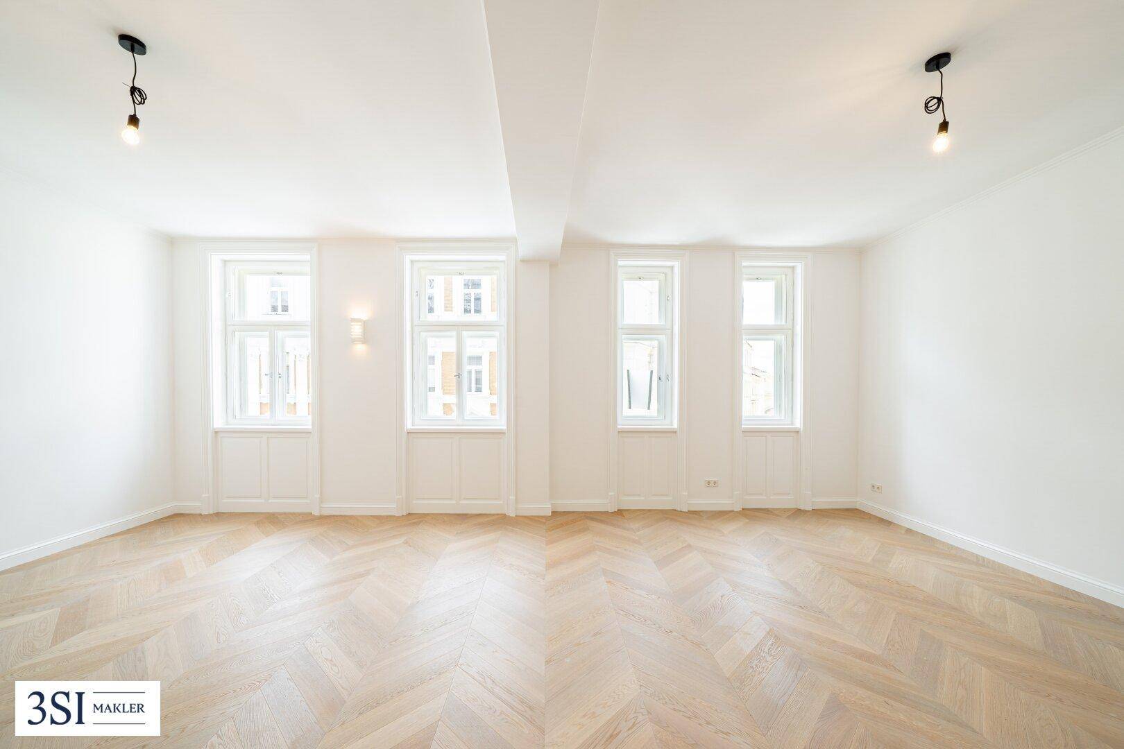Helles, leeres Zimmer mit Fischgrätparkett und hohen Fenstern, bereit zur individuellen Gestaltung.