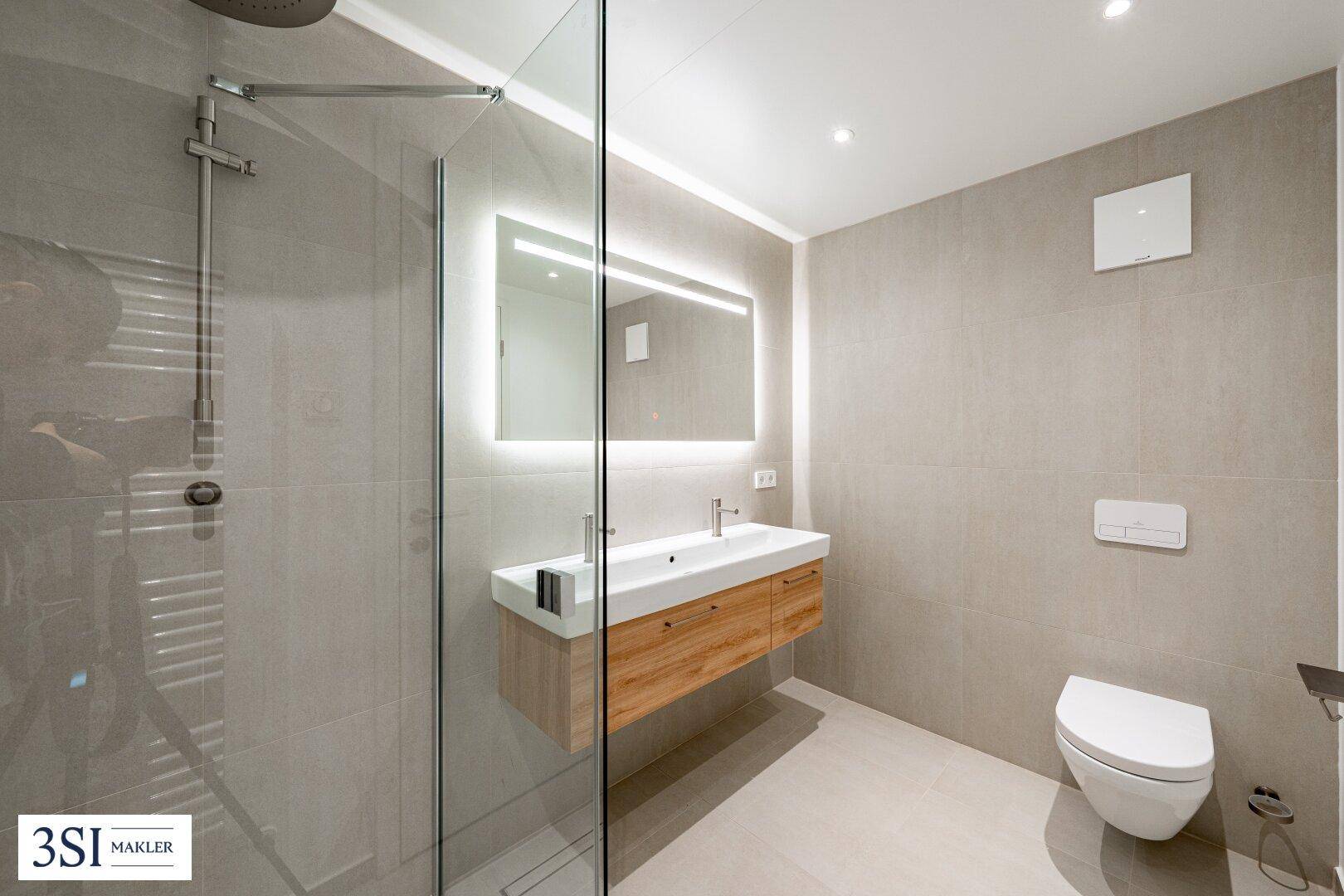 Zeitgemäßes Badezimmer mit Dusche, Wand-WC und schwebendem Waschtischunterschrank, funktional und stilvoll gestaltet.