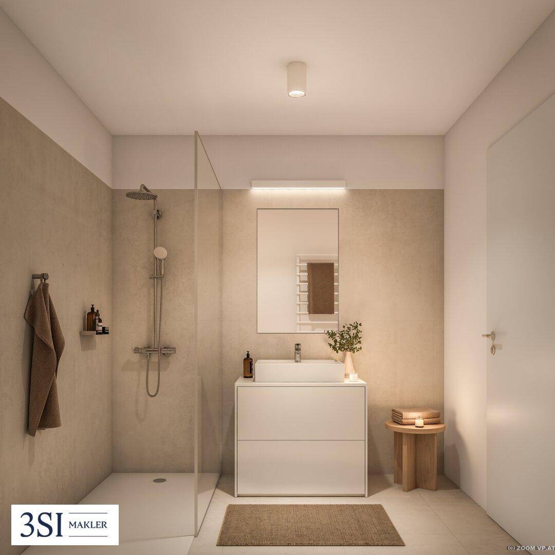 Modernes Badezimmer mit ebenerdiger Dusche, elegantem Waschtisch und beheiztem Handtuchhalter.
