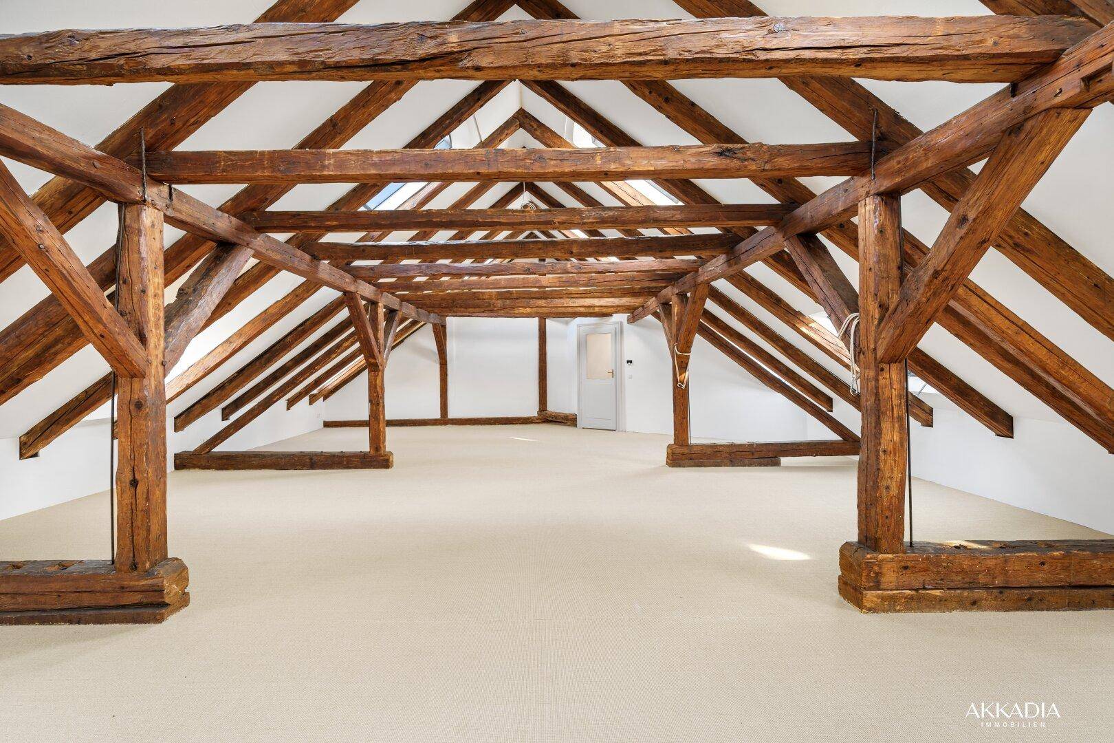 Geräumiger Dachboden mit beeindruckenden freiliegenden Holzbalken und viel Potenzial für Ausbau.