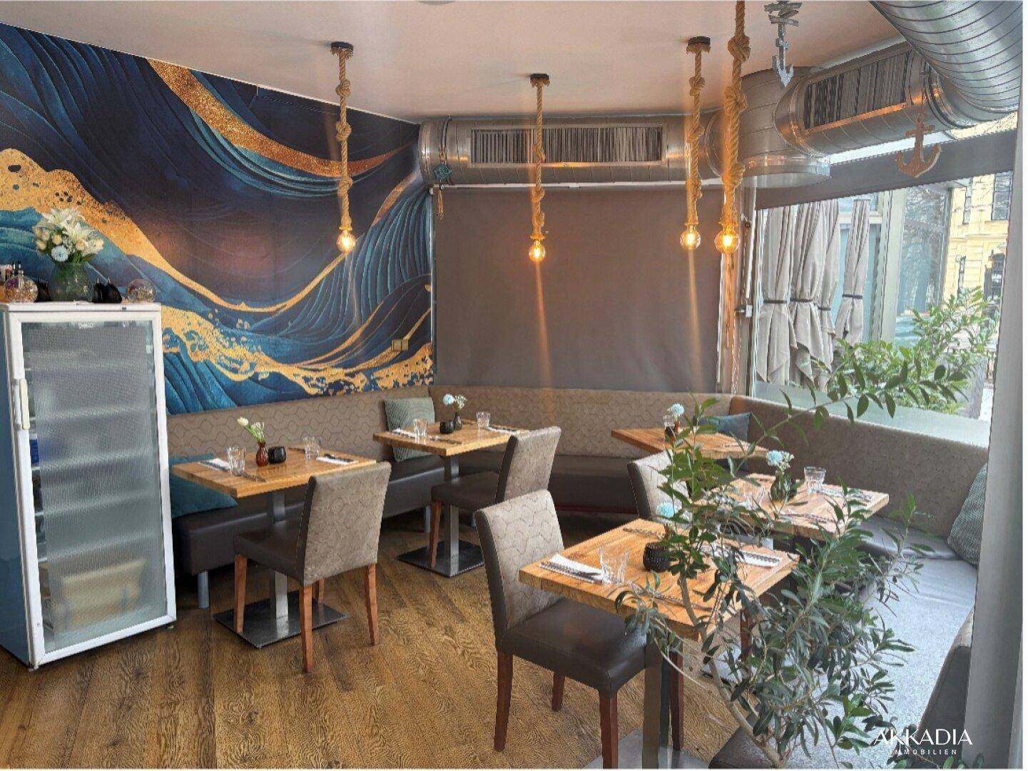 Modern eingerichteter Innenbereich eines Restaurants mit Wandgemälde, Holzböden und Seillampen.
