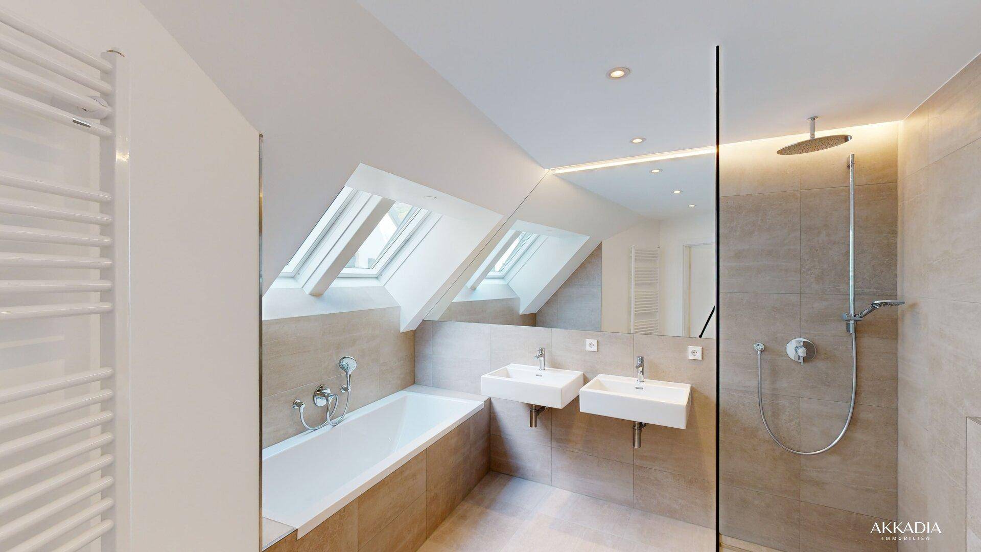 Modernes Badezimmer im Dachgeschoss mit Badewanne, Doppelwaschbecken und großer begehbarer Dusche.