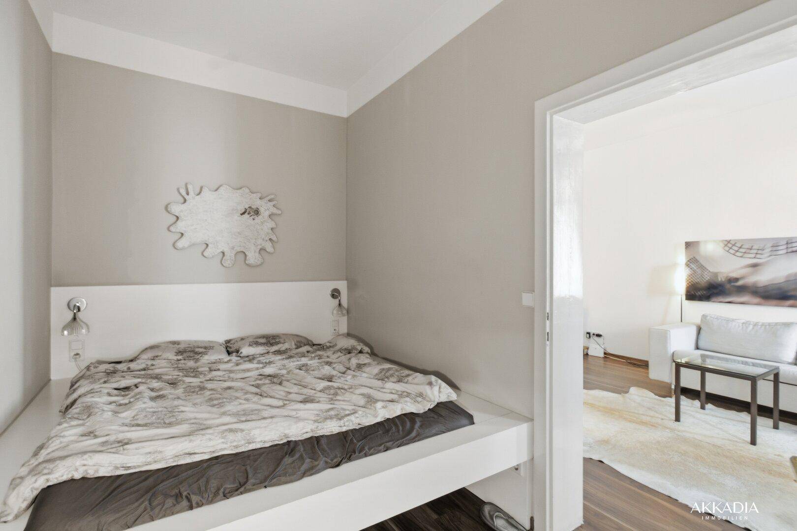 Schlafzimmer mit modernem Podestbett und direktem Zugang zum Wohnbereich.