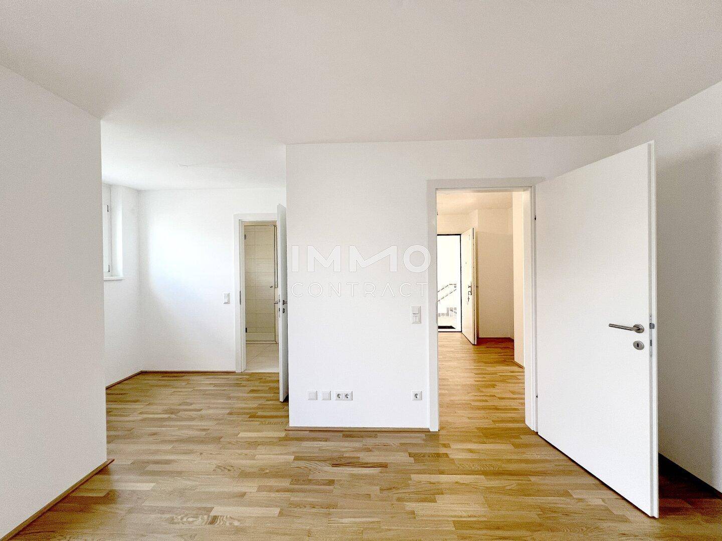 Heller Flurbereich mit Parkettboden und Zugang zu verschiedenen Zimmern der Wohnung.