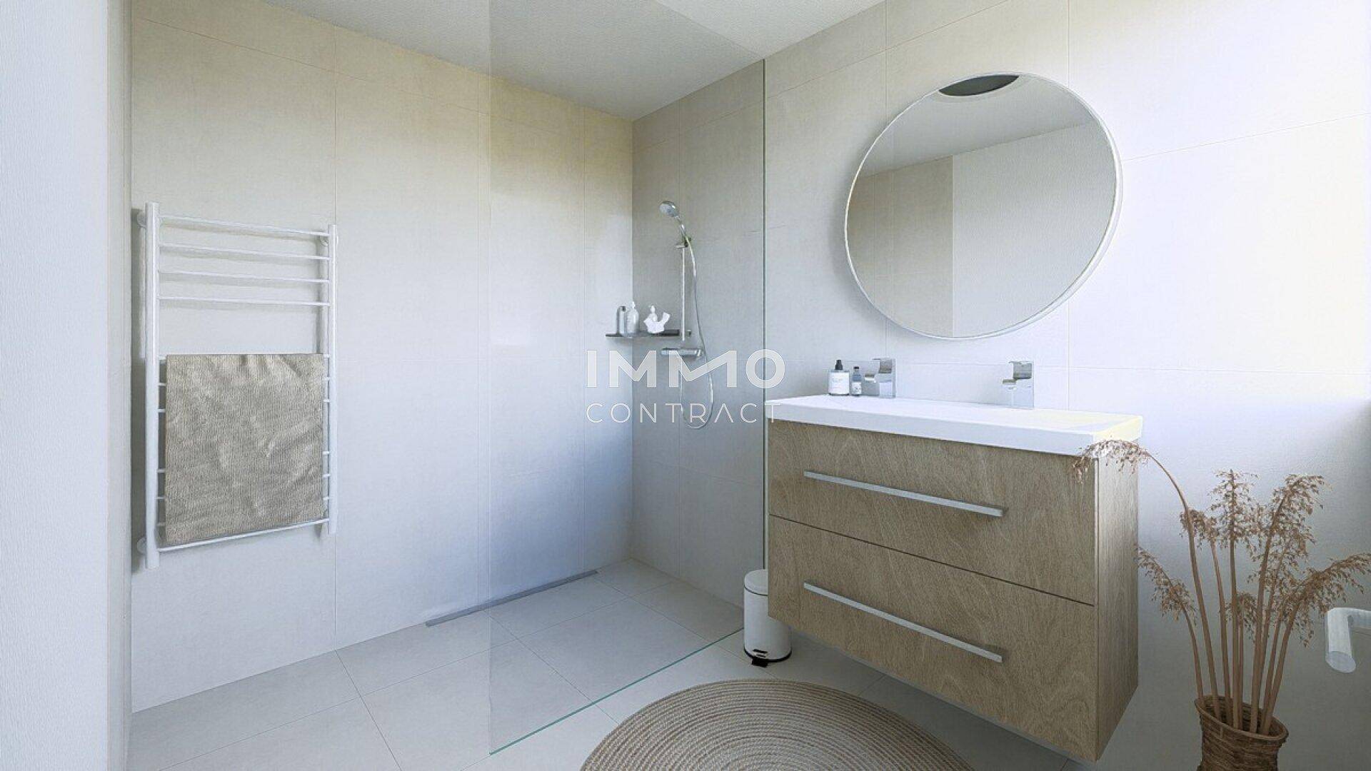Modernes Badezimmer mit ebenerdiger Dusche, Einzelwaschbecken und beheiztem Handtuchhalter.
