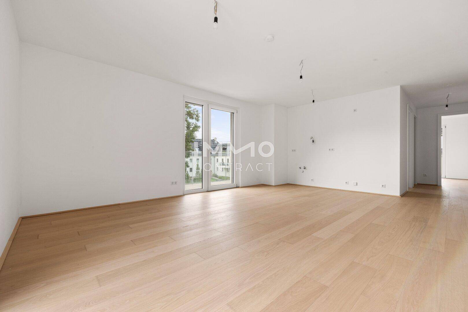 Geräumiges, helles Zimmer mit Holzboden und großen Fenstern, ideal für individuelle Gestaltung.