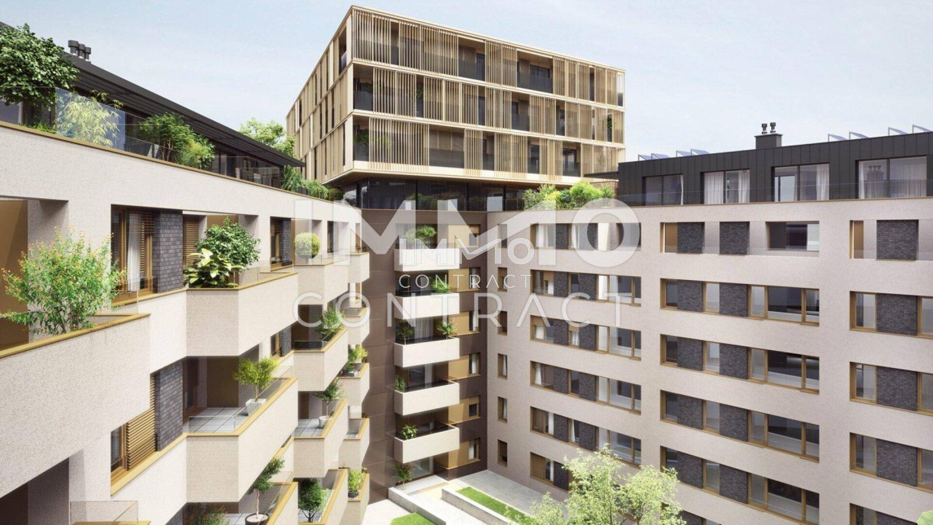 Innenhofansicht des Wohnkomplexes mit begrünten Balkonen und moderner Architektur.