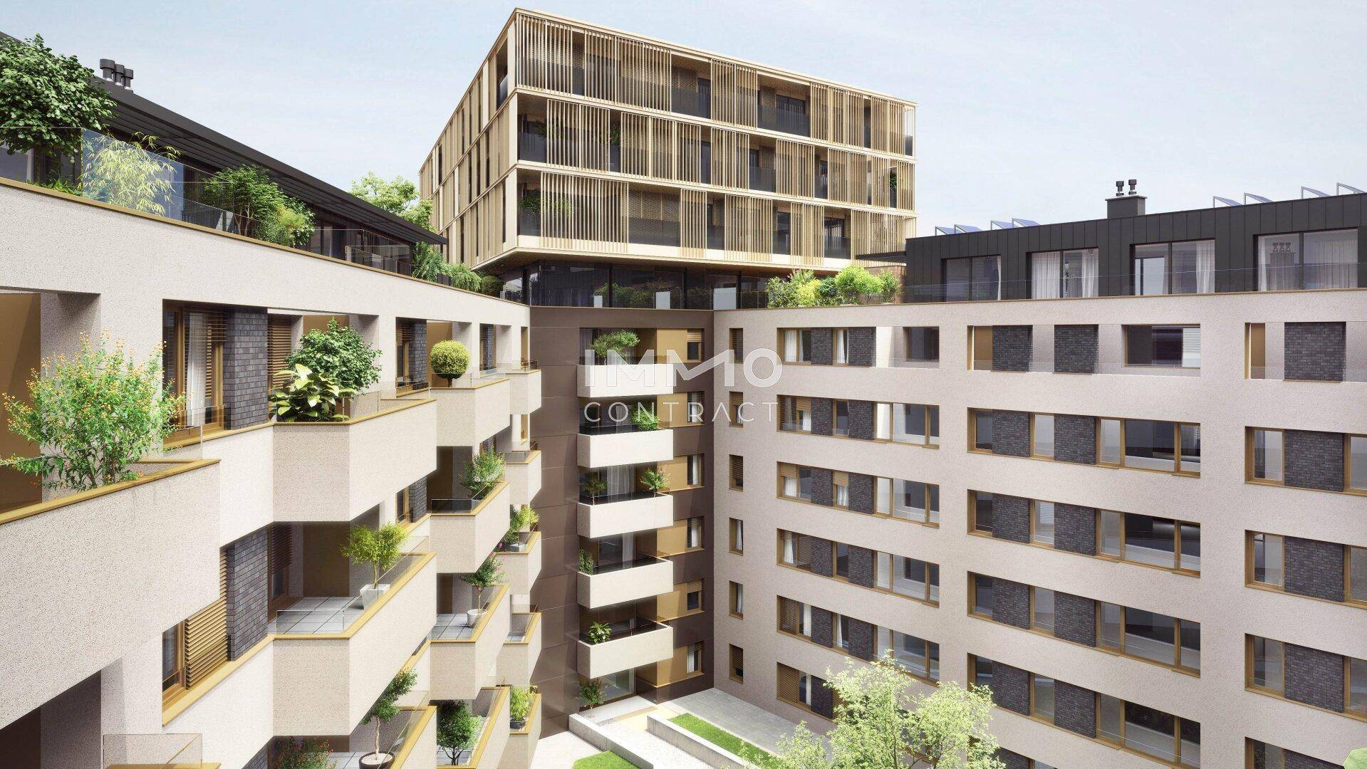 Moderne Wohnanlage mit mehreren Gebäuden, Balkonen und begrünten Zwischenräumen.