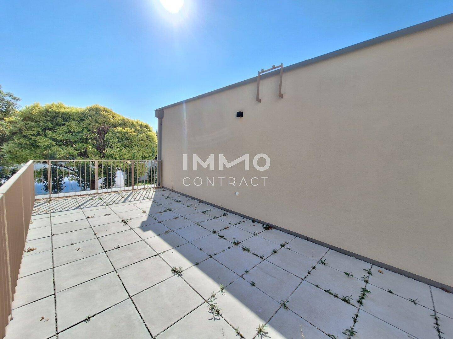 Sonniger Außenbereich mit Fliesenboden und Metallgeländer, ideal für Entspannung im Freien.