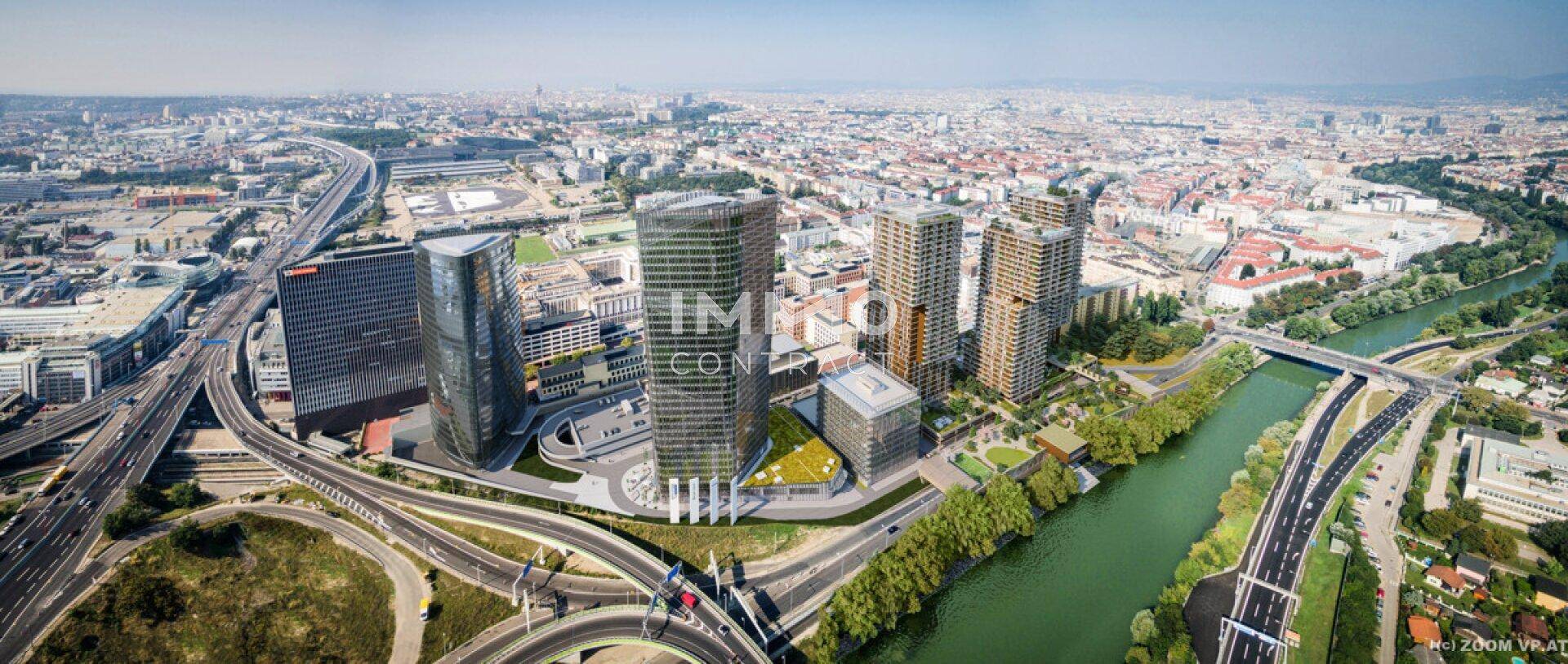 Luftaufnahme einer modernen Stadtlandschaft mit Hochhäusern, Autobahnen und einem Fluss.