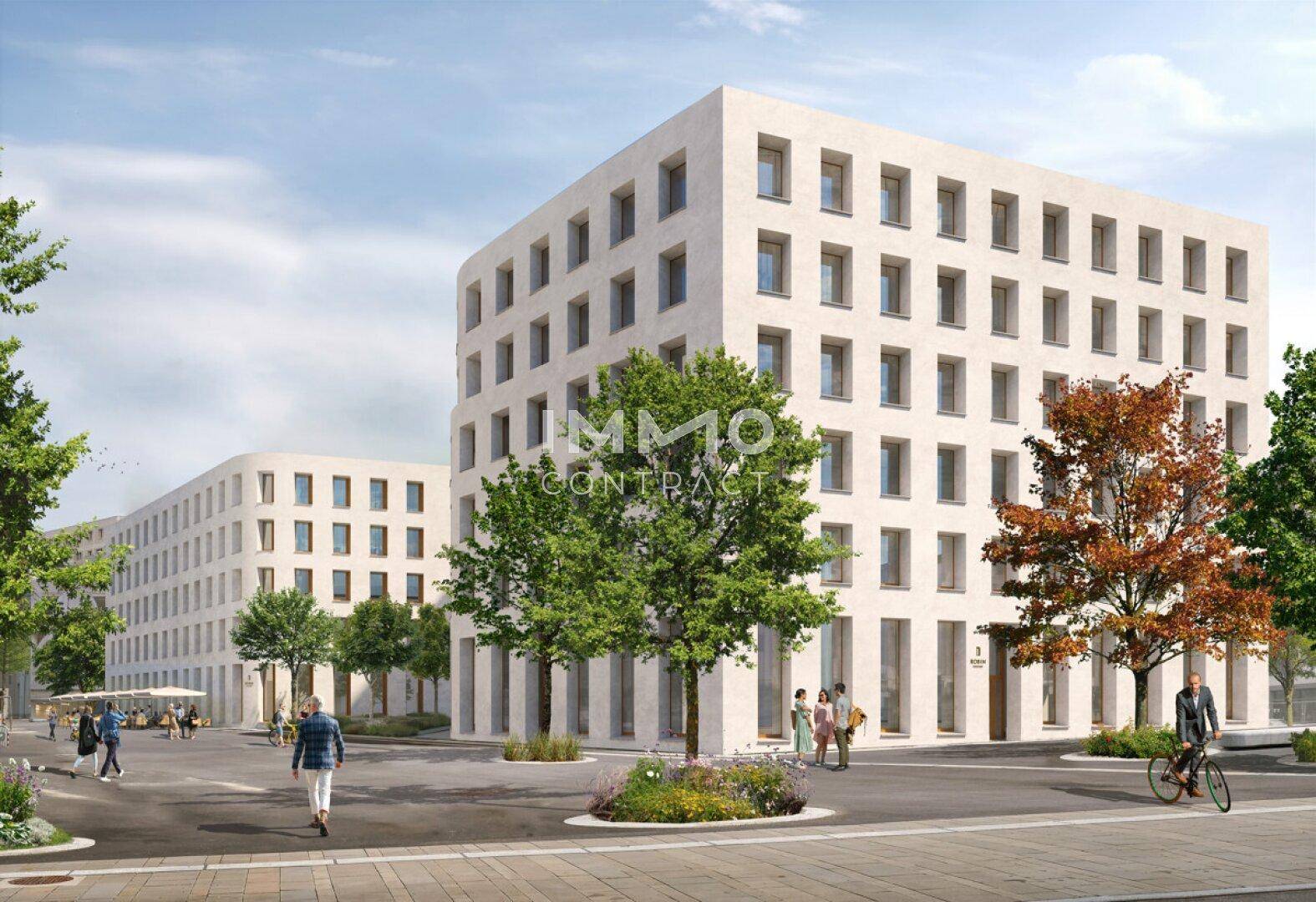 Ansicht eines modernen Bürogebäudes mit klarer Linienführung und begrüntem Umfeld in der Seestadt.